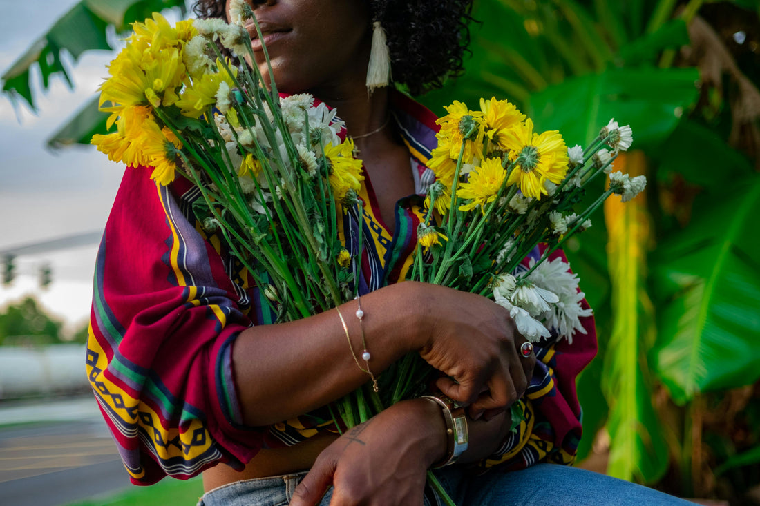 She Kitty: Women's Sexual Health customer holding flowers.